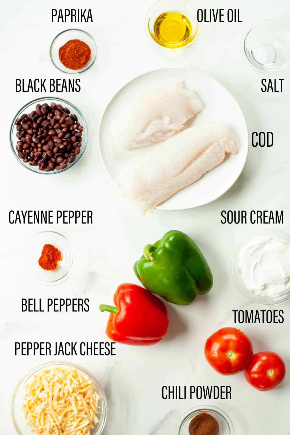 ingredients for seafood stuffed peppers laid out on white marble surface with black text