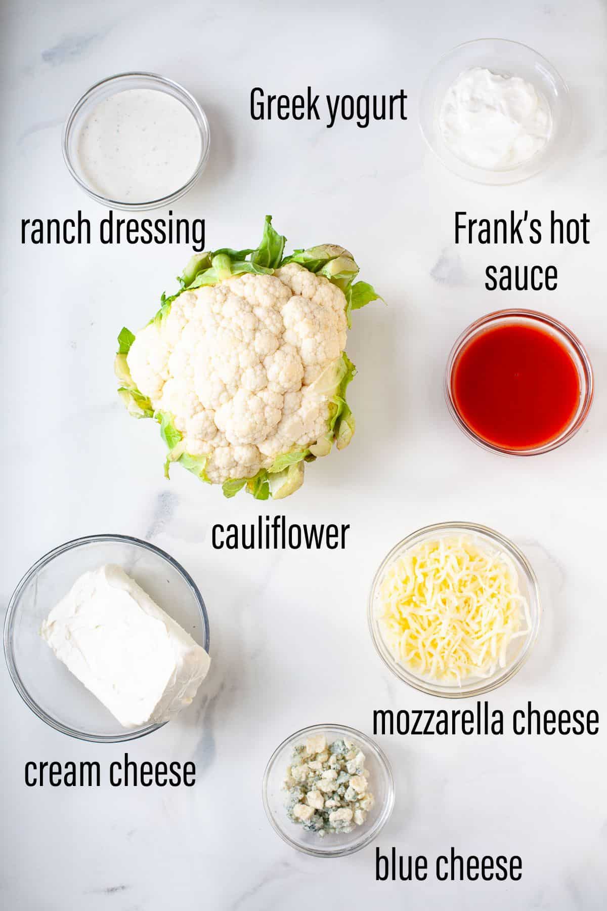 graphic of ingredients for buffalo cauliflower dip on marble surface with black text overlay